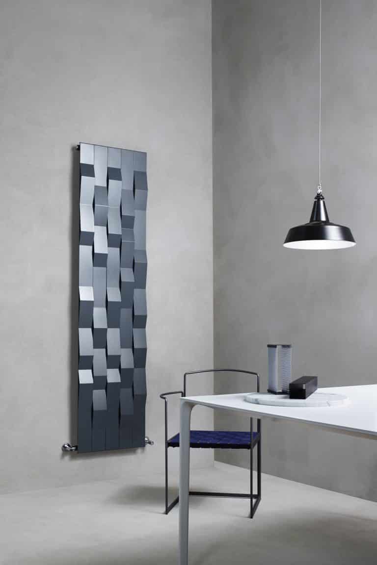 Betonová stěrka v jídelně, stůl a kovová židle, designový šedý radiátor Stone